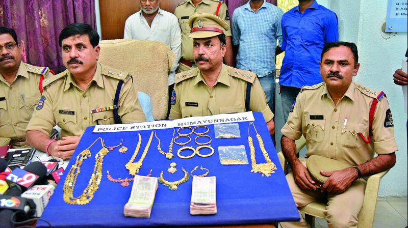 Police officials display seized gold ornaments at a press conference in the city on Wednesday. (Photo: DC)