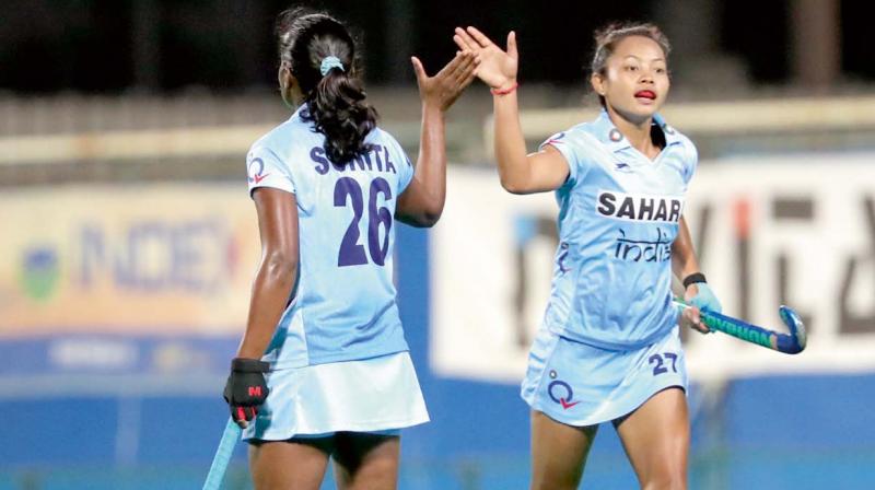 Sushila Chanu (right) and Sunita celebrate Indias 4-2 win over Japan in the womens Asian Cup semi-final.