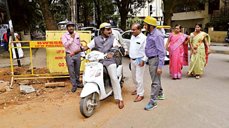 Mayor Sampath Raj inspects the roads in various parts of the city on a two-wheeler on Wednesday (Photo: DC)