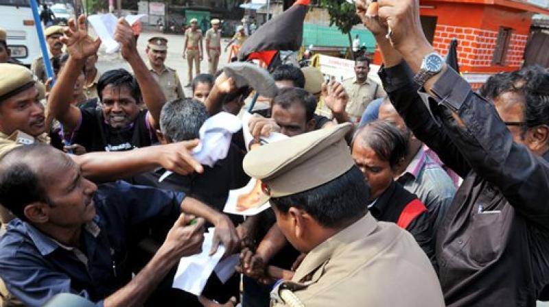 Members of Thandhai Periyar Dravida Kalagham raising slogans during a protest against BJP leader Subramanian Swamy in Coimbatore. (Photo: AP)
