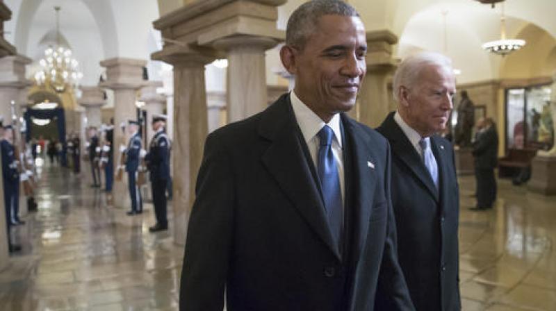 President Barack Obama and Vice President Joe Biden walk through the Crypt of the Capitol for Donald Trumps inauguration ceremony, in Washington. (Photo: AP)