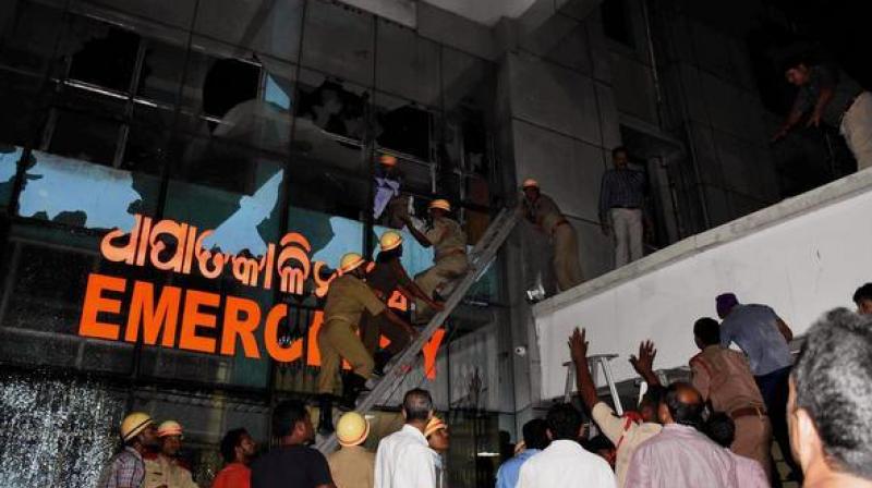 Rescue team in action at SUM Hospital where a fire broke out on Monday night, in Bhubaneswar. (Photo: PTI)