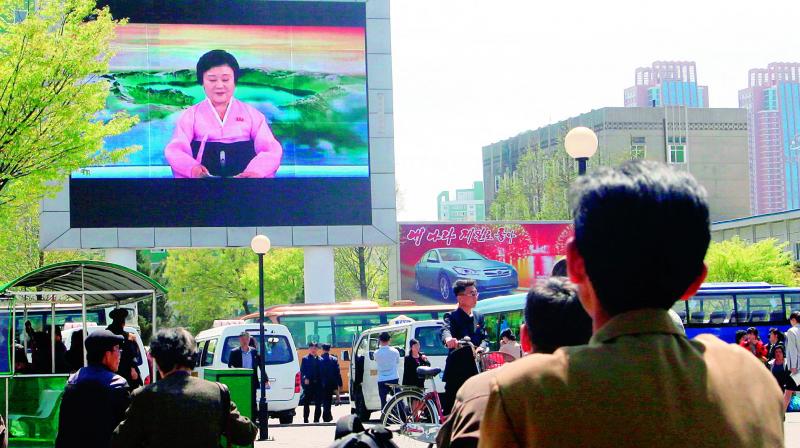 North Koreans watch as their countrys most famous newscaster announces leader Kim Jong Uns proposal to suspend nuclear tests on Saturday.  (Photo:AFP)
