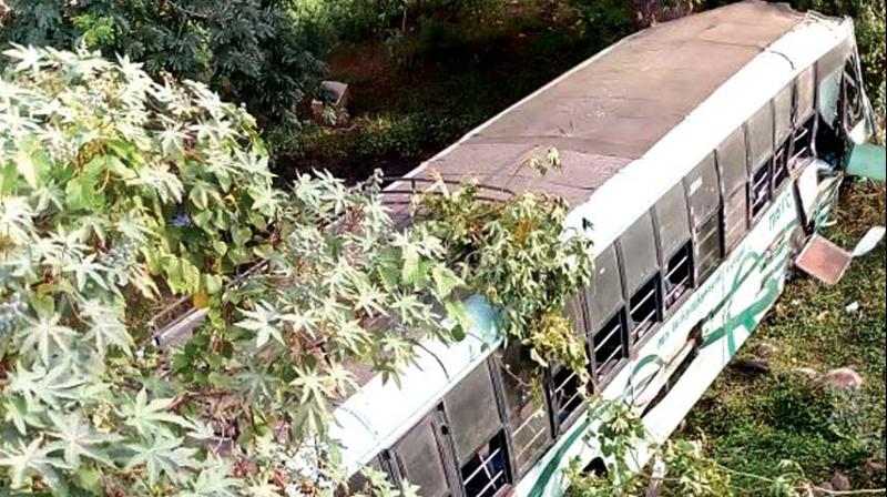 The bus lies in a ditch on GST Road on Saturday  morning.	(Photo:DC)
