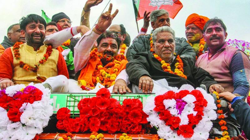 BJP candidate Krishan Middha with party leader Krishna Lal Panwar during a victory rally after winning the Jind Assembly seat in Haryana.