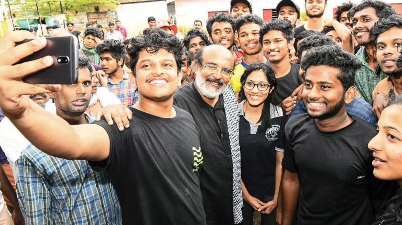 Volunteers take selfie with finance mninister Thomas Isaac who joined them for the clean-up work on Tuesday.