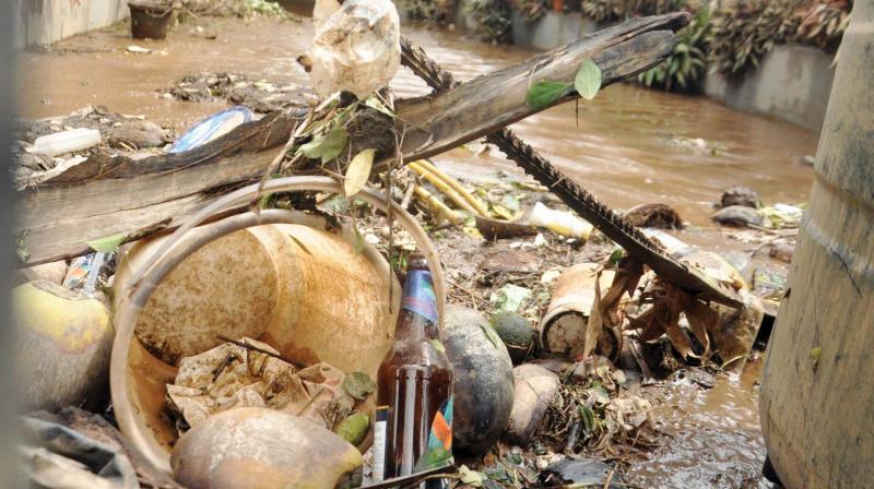 The waste gathered by flood waters seen piled up before a house near Paravur Jn. in Aluva, one of the worst flood ravaged regions in Kochi. (File pic)