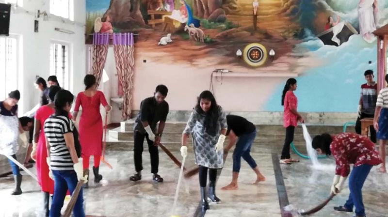 NSS volunteers of Sacred Heart College, Thevara, involved in cleaning works on Tuesday.(Photo: DC)