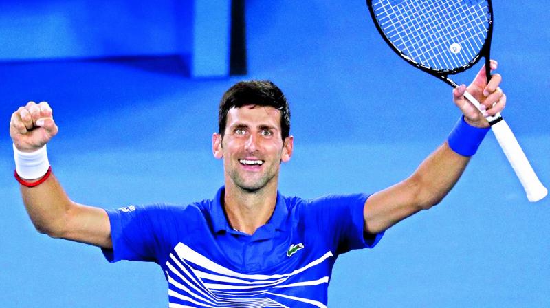 Novak Djokovic of Serbia celebrates after defeating Lucas Pouille of France in their mens singles semifinal at the Australian Open tennis championships in Melbourne on Friday. Djokovic won 6-0, 6-2, 6-2. (Photo: AP)