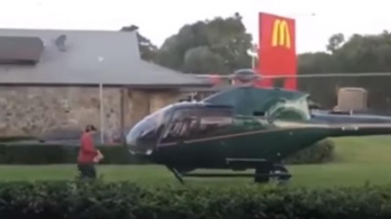 The man stopped by the Sydney McDonalds to pick up a parcel and flew off after he clicked a photograph of it. (Photo: Youtube)