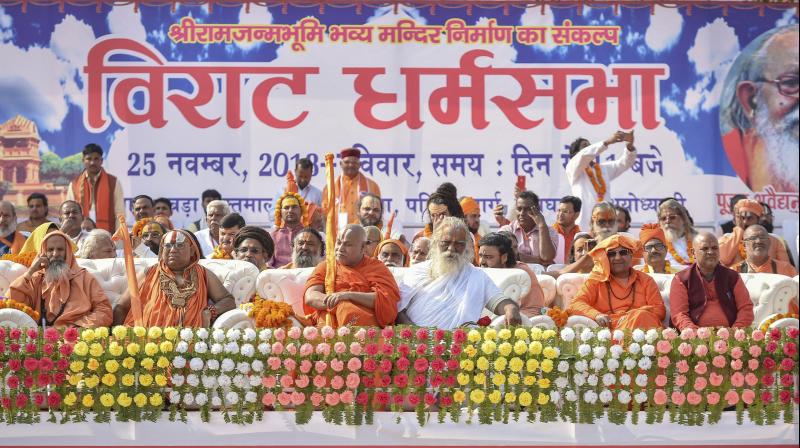 Seers from different ashrams gather at the programme venue as they participate in Dharam Sabha, organised by the VHP. (Photo: PTI)