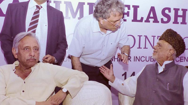 Historian Ramachandra Guha speaking to Congress leader C.K. Jaffer Sharieff on the sidelines of a discussion Kashmir Flashpoint in Bengaluru on Monday. Also seen is Congress leader Mani Shankar Aiyar. (Photo: R. Samuel)