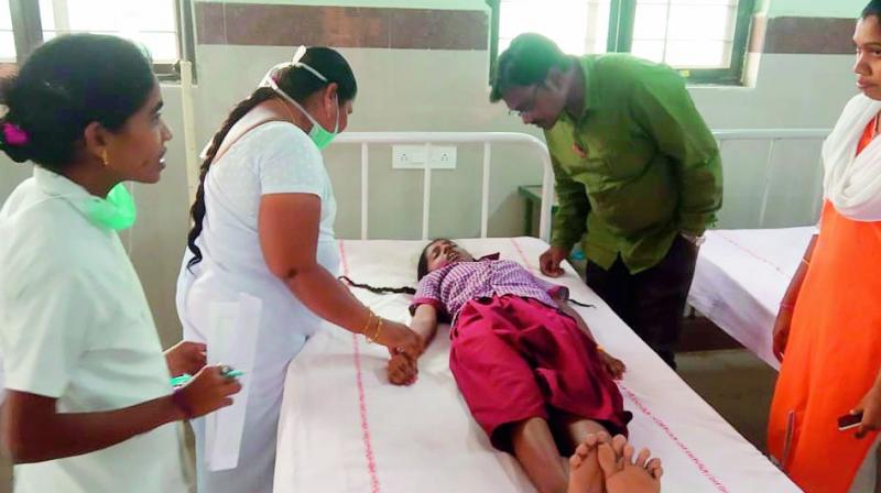 Doctors attend to one of the students who was admitted to the government hospital in Chityal on Monday. ( Photo: DC)