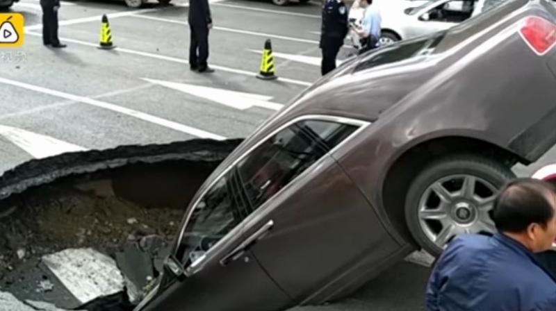 This is the amazing moment a huge sinkhole swallowed a Â£560,000 Rolls Royce supercar.