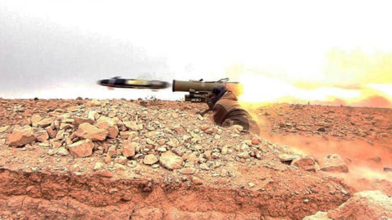 A gunman firing an anti-tank missile at Syrian troops north of Palmyra city, in Homs Provence, Syria. (Photo: AP)