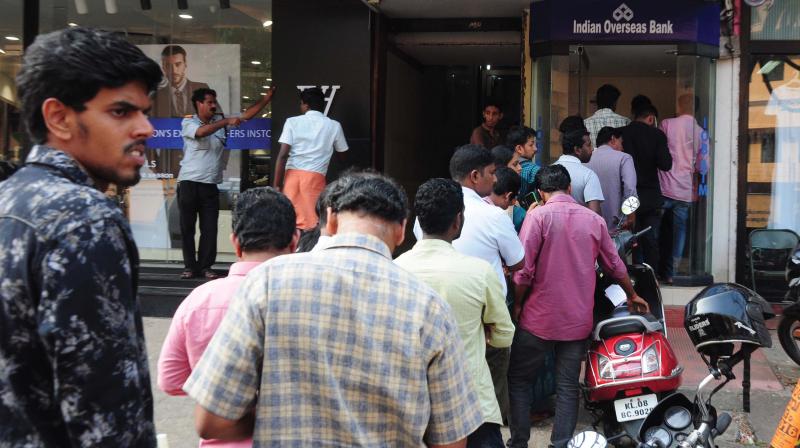 People stand in a queue at an ATM counter near Palace Road in Thrissur on Saturday.  (Photo: Anup K. Venu)