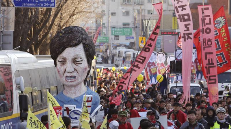 Protestors carrying an effigy of former President Park Geun-hye. (Photo: AP)