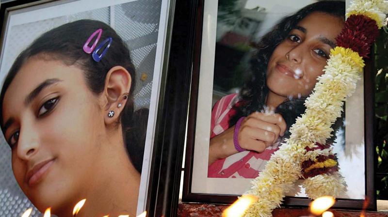 In this file photo, friends and relatives of Aarushi Talwar light candles near her portrait to seek justice for her, at Jantar Mantar in New Delhi. The Allahabad high court on Thursday acquitted her parents Rajesh and Nupur Talwar in her murder case. (Photo: PTI)