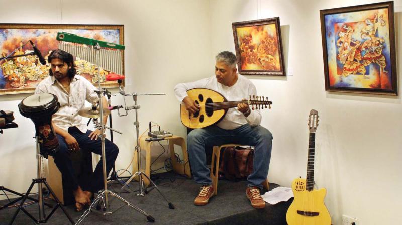 (Right) Jagadeesh M.R., director, Bangalore School of Music, plays the oud at a local art gallery.