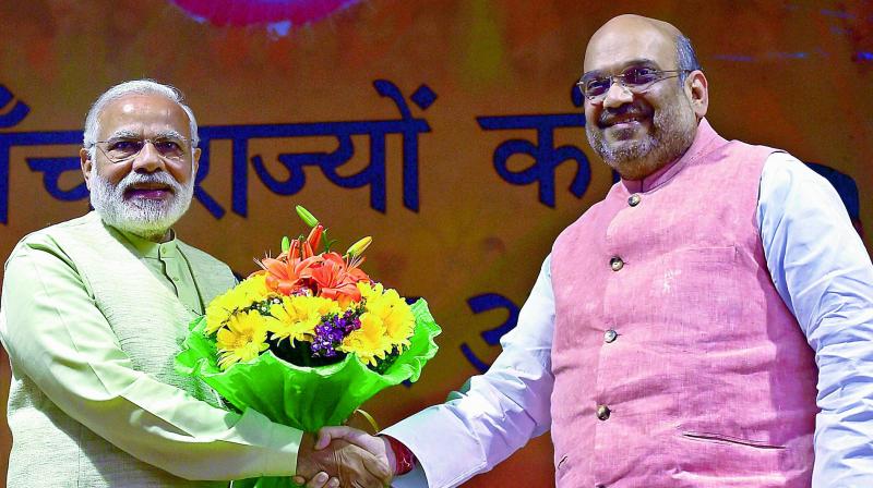 BJP president Amit Shah greets Prime Minister Narendra Modi at the partys parliamentary board meeting in New Delhi on Sunday. (Photo: PTI)