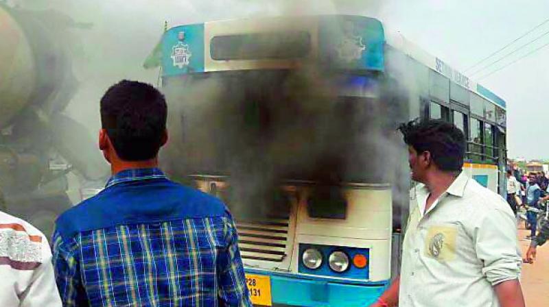 Smoke comes out of a Setwin bus at Shamshabad on Sunday