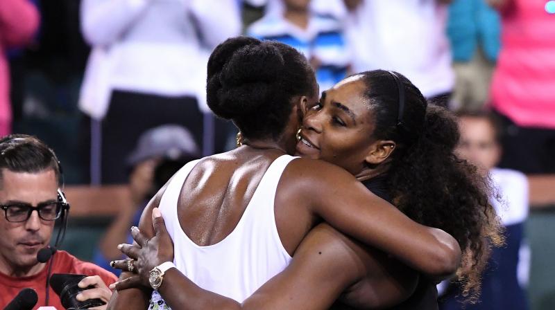 Venus Williams (white) defeated younger sister Serena Williams 6-3, 6-4 in the third round of the BNP Paribas Open. (Photo: AP)
