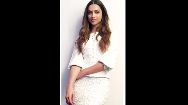 Deepika Padukone rocks an all-white ensemble and accents them with strappy beige-gold heels