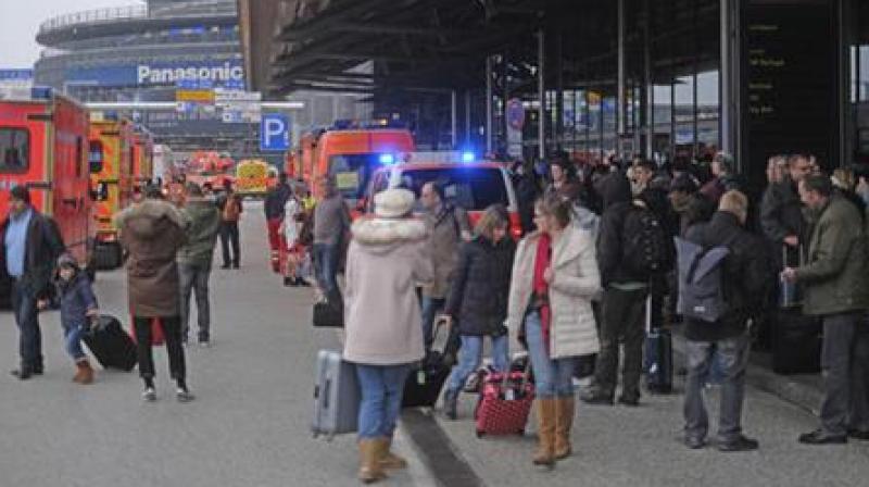 Travellers wait outside the Hamburg, northern Germany, airport Sunday, Feb. 12, 2017 after after several people were injured by an unknown toxic that likely spread through the airports air conditioning system. (Photo: AP)