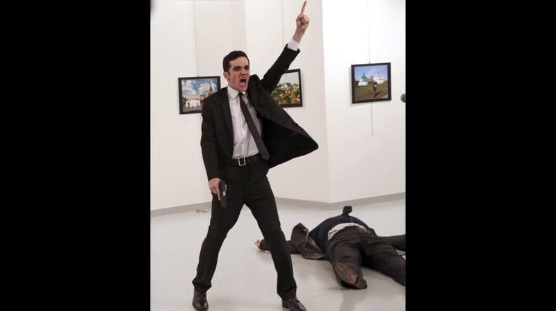 Mevlut Mert Altintas shouts after shooting Andrei Karlov, right, the Russian ambassador to Turkey, at an art gallery in Ankara, Turkey. (Photo: File/AP)