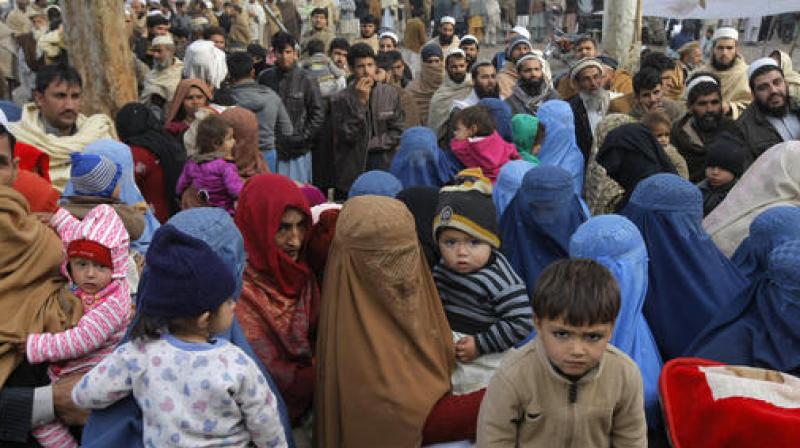 Afghan refugee families wait for their turn to be registered, outside the government registration office in Peshawar, Pakistan. (Photo: AP)