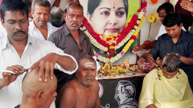 Scores of staunch supporters of former chief minister J. Jayalalithaa tonsured their heads to mourn the death of their beloved Ammain Tamil Nadus Coimbatore district on Tuesday. (Photo: PTI)