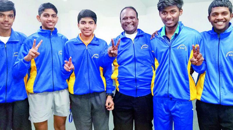Members of the Telangana Under 19 boys table tennis team flash victory signs after winning a silver medal at the National School Games championships held in New Delhi.