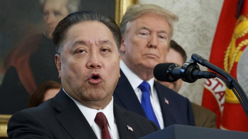 This photo shows Broadcom CEO Hock Tan speaking while US President Donald Trump listens, in background, during an event at the White House in Washington, to announce the company is moving its global headquarters to the United States. (AP Photo/Evan Vucci, File)