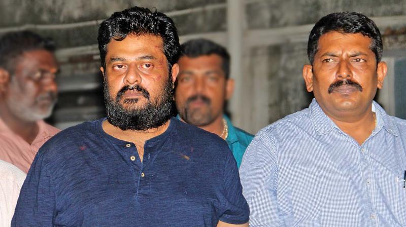 Vendhar Movies S. Madhan (left) being taken to be produced before a metropolitan magistrate, from the Egmore office of the CCB sleuths, on Monday evening (Photo: DC)