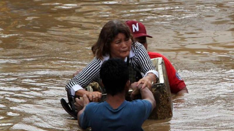 A search and rescue operation was underway for more than 30 people who have been swept away by flash floods in the fishing village of Anungan. (Photo: AFP)