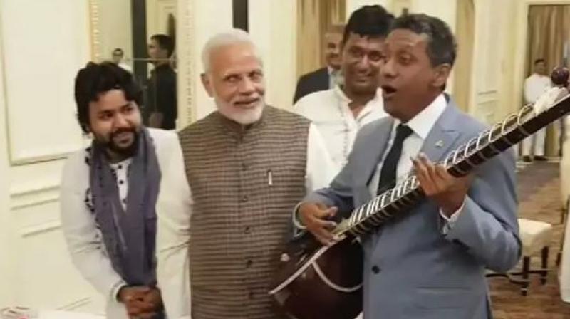 Seychelles President Danny Faure is seen singing a song as Prime Minister Narendra Modi and others present applaud his effort. (Photo: Screengrab | Twitter @MEAIndia)