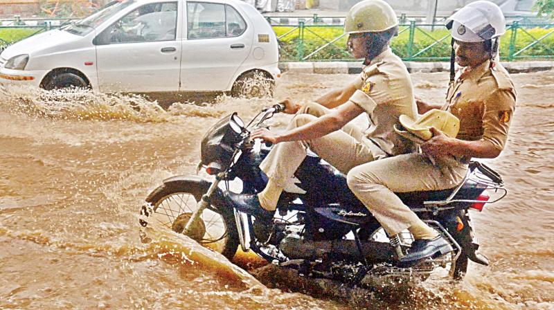 Due to incessant rains on Tuesday night and Wednesday, many roads in the city got water-logged. Motorists struggle to pass through Cubbon Road 	Shashidhar B.