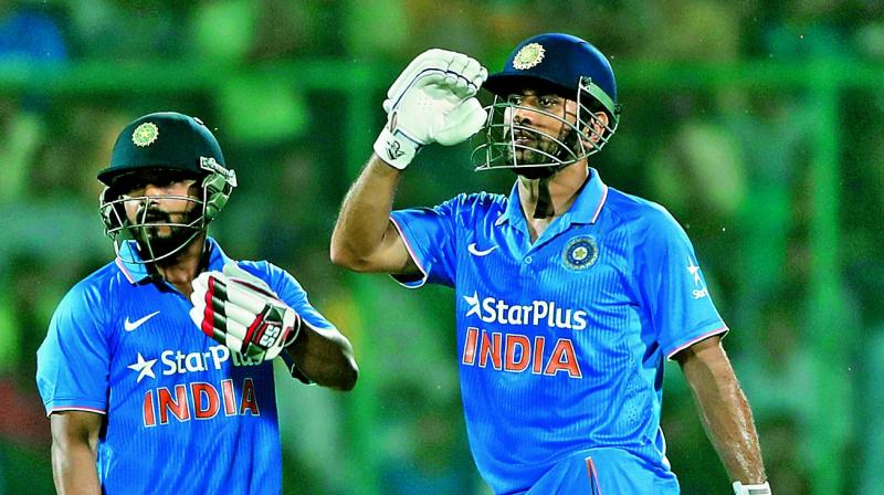 M.S. Dhoni (right) admitted that he made a mistake by opting to bowl on a sluggish wicket. (Photo: PTI)