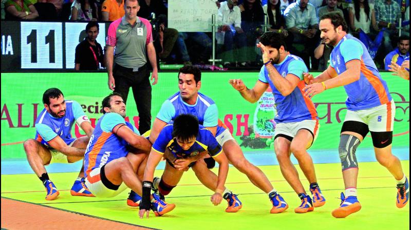 Players of the Indian team trap a Thailand player during their World Cup kabaddi semifinal in Ahmedabad on Friday. India won 73-20.