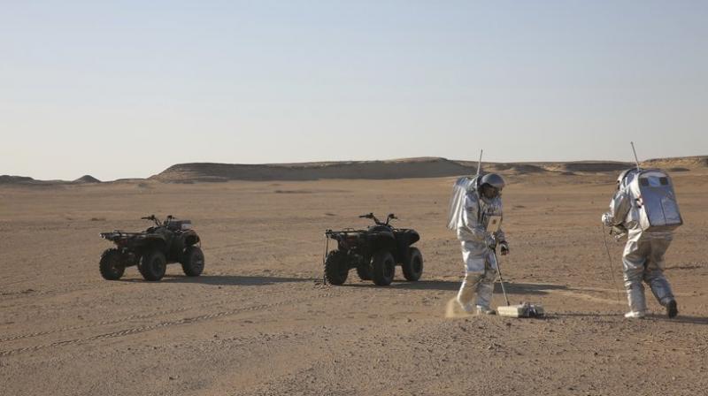 This photo shows two scientists test space suits and a geo-radar for use in a future Mars mission in the Dhofar desert of southern Oman. The desolate desert in southern Oman resembles Mars so much that more than 200 scientists from 25 nations organized by the Austrian Space Forum are using it for the next four weeks to field-test technology for a manned mission to Mars. (Photo: AP)