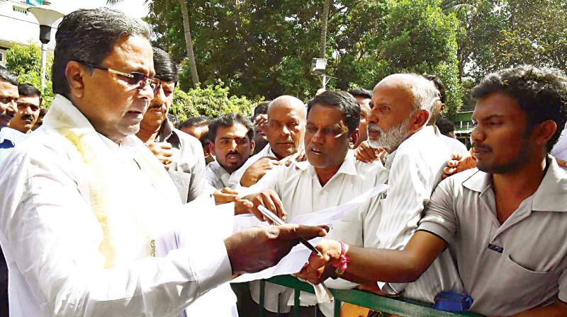 Chief Minister Siddaramaiah hears the grievances of the public at his home office, Krishna in Bengaluru on Tuesday. (Photo: DC)