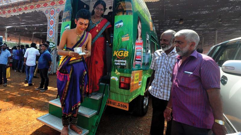 A participant comes out of the mobile ATM of Kerala Gramin Bank installed at Nila, one of the Kalolsavam venues. (Photo: DC)