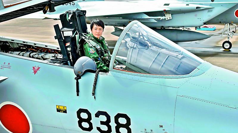 First Lieutenant Misa Matsushima of the Japan Air Self Defence Force poses in an F-15J air superiority fighter at Nyutabaru airbase in Japan on Thursday. (Photo: AFP)