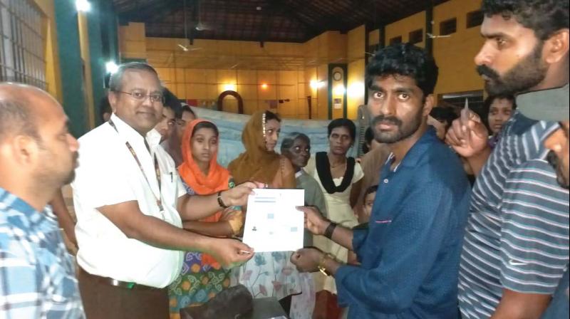 Officials providing Aadhaar card to the flood victims in Jodupala and nearby villages.(Image Dc)