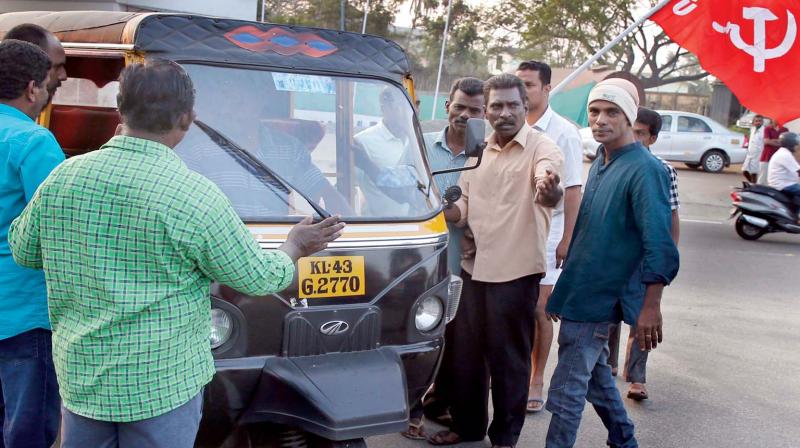 Protestors block an autorikshaw at the entrance of Willingdon Island in Kochi on Tuesday in connection with the two-day nation-wide general strike.