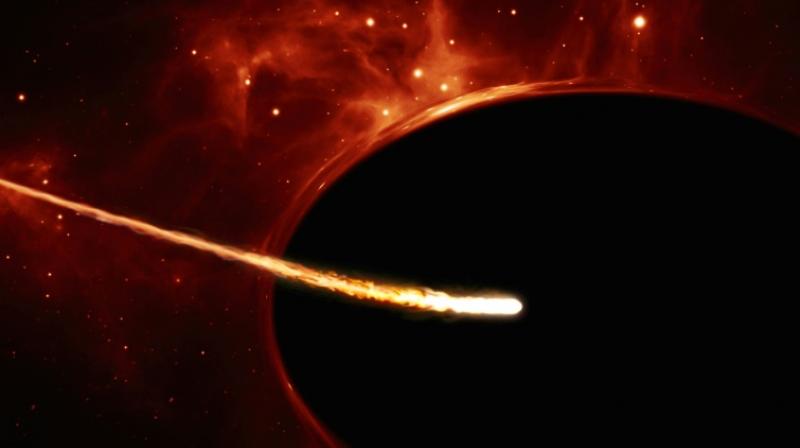 An artists impression released on December 9, 2016 by the European Space Agency shows a Sun-like star close to a rapidly spinning supermassive black hole