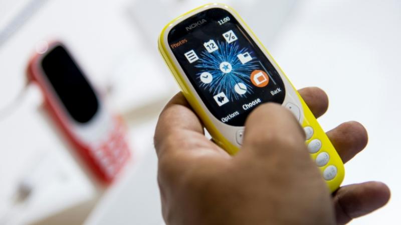 The number of mobile phone users globally will top 5 bn by the middle of this year, according to a study. (Photo: AFP)