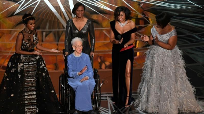 NASA physicist Katherine Johnson (C), whose likeness is set to be made into a Lego, is surrounded by Hidden Figures actresses Janelle Monae (L), Taraji P. Henson (2ndR) and Octavia Spencer (R) as they present on stage at the Oscars February 26, 2017 (Photo: AFP)