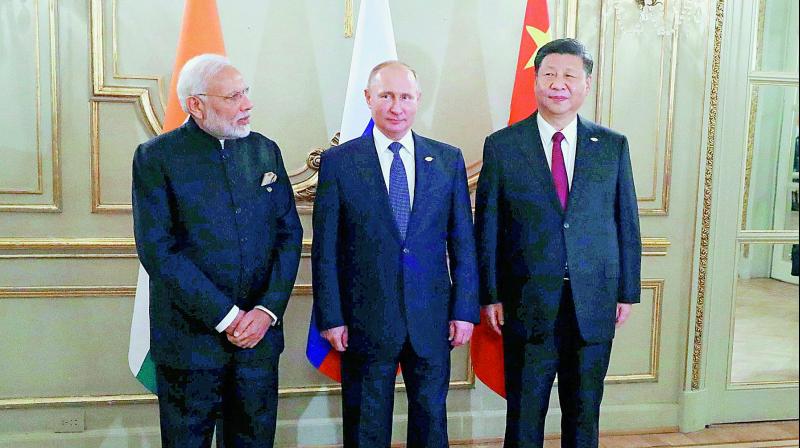 Prime Minister Narendra Modi, left, Russian President Vladimir Putin, center, and Chinese President Xi Jinping, during their meeting at the G20 summit in Buenos Aires, Argentina. 	(AP/PTI)