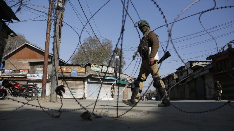 An Indian paramilitary soldier guards at a check point during a strike in Srinagar, Indian controlled Kashmir. (Photo: AP)